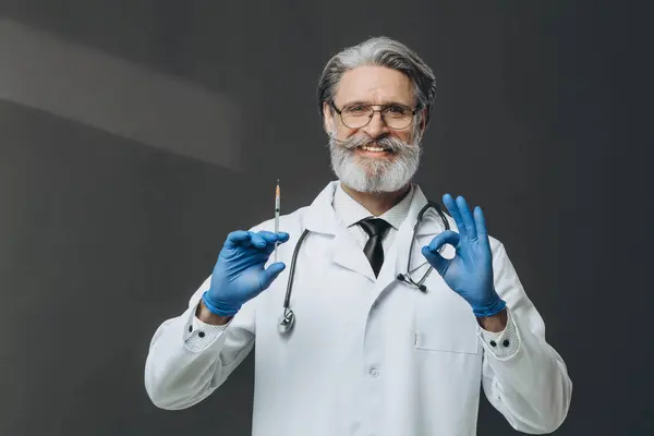 Senior Doctor Grey Hair Holding Syringe Doing Sign Fingers Smiling — Stock Photo, Image
