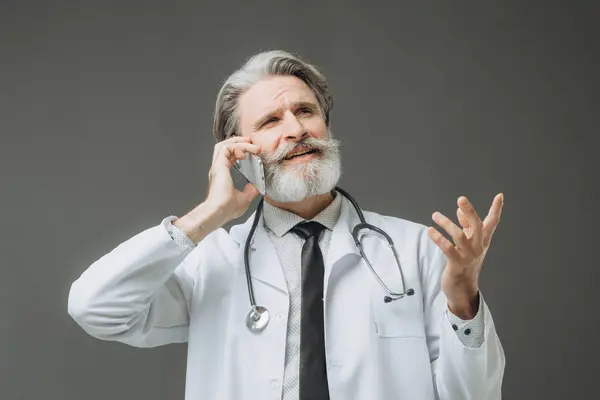 Male Doctor Talking Phone Isolated Gray Background Royalty Free Stock Images
