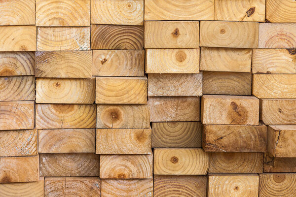 Pine wood planks stored in a sawmill for use in construction.