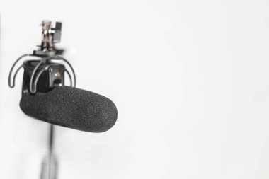 Home studio podcast interior. Microphone, laptop and on air lamp on the table, close-up