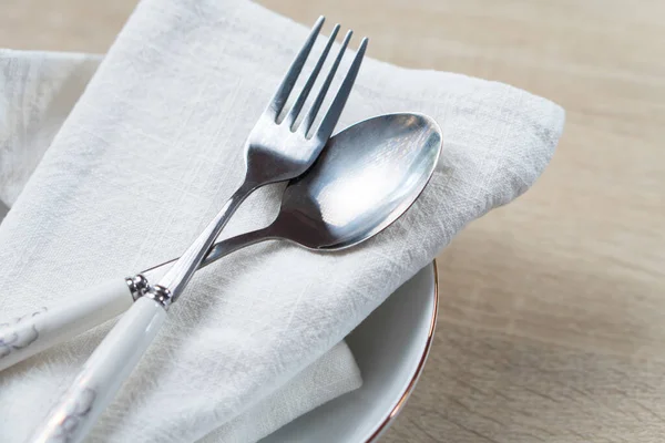 High Angle View of Silver Cutlery Set in Linen Napkin