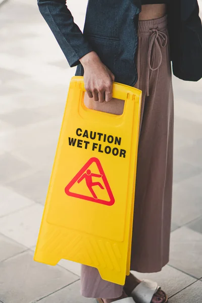 cleaning in progress sign on yellow plastic board on floor