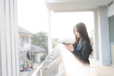 Açık havada tablet kullanan Asyalı İş kadını