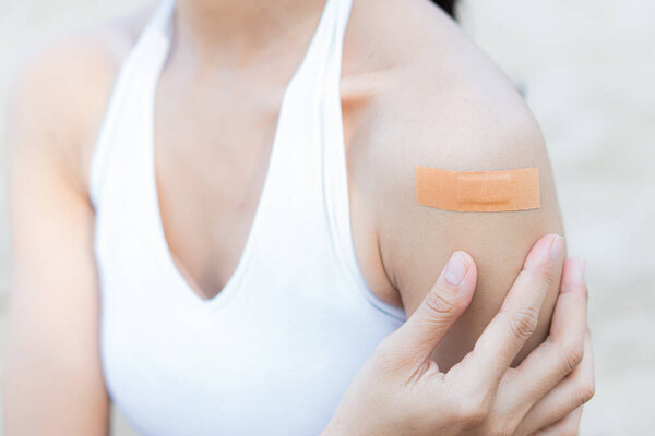 woman arm with an adhesive bandage