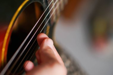 man playing guitar in the hands of the music