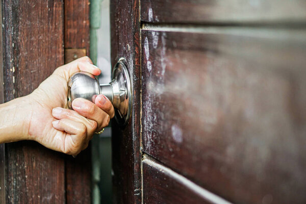 man hand holding door lock