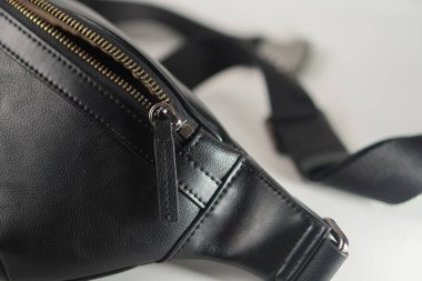 A close-up view of a stylish black leather bag with a zipper, showcasing its sleek design and high-quality material. clipart