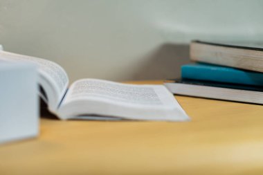 Çalışma, öğrenme ve akademik kavramları temsil eden açık ve ahşap bir masanın üzerine dizilmiş defterler. Eğitim temaları ve verimlilik için ideal.