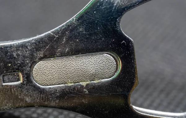 Close up of Nail file at the center of the nail clipper, macro photo, detailing texture