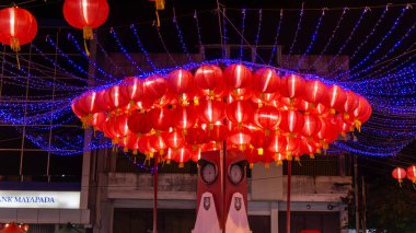 Festively Illuminated Red Lantern Display in Nighttime Urban Setting clipart