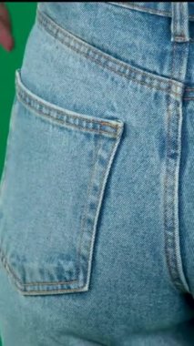 Female hand climbs into the pocket of jeans on the ass. High quality FullHD footage