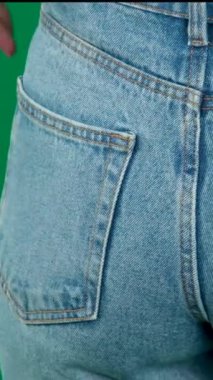 Female hand climbs into the pocket of jeans on the ass. High quality FullHD footage