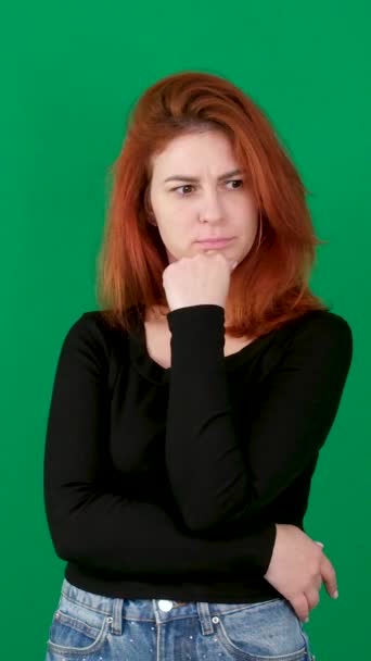 Dikey Video Kızıl Saçlı Genç Bir Kadın Yeşil Bir Arka — Stok video
