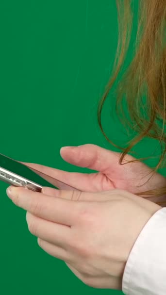 Girl Uses Smartphone Green Background Girl Flips Her Finger Smartphone — Stock Video