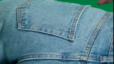Female hand climbs into the pocket of jeans on the ass. High quality FullHD footage
