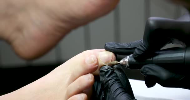 美容院修脚专业的主人在美容院修指甲的过程中负责洗脚特写视频 在黑色手套广告中做按摩 妇女的生活视频 — 图库视频影像