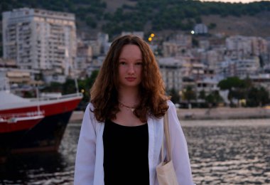 Güzel gülümseyen genç kız Abania turisti, yaz parkının yeşiline karşı. Sokak ve arka planda Bokeh etkisi olan insanlar. Güzel bir kızın portresi. Yüksek kalite fotoğraf