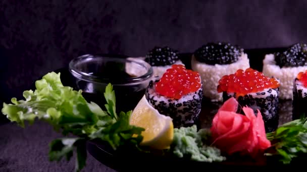 Close Uramaki Sushi Rolls Red Caviar Salmon Tuna Cucumber Avocado — Stock Video