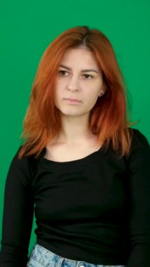 Siyah elbiseli kızıl saçlı bir kız farklı duygular ifade eder. Oh, özür dilerim, ellerimi birleştirmek istememiştim. Saçları yeşil arka planda genç bir kadın. Krom anahtar stüdyosunda. Yakın çekim kahverengi gözler. 
