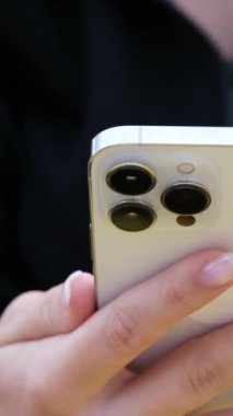 Cep telefonu kullanan genç bir kadının elleri, ağır çekimde. Dikey video, yüksek kalite 4k görüntü