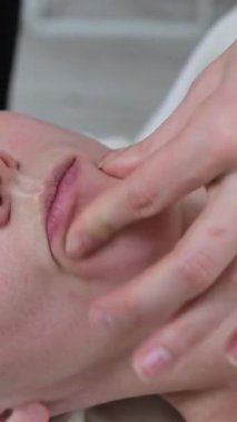 Prosedür, yüz masajına yakın olmak. Cilt tazeleme için masaj. Dudak ve yanak masajı. Japon tekniği kullanarak Buccal masaj. Yüksek kalite 4k görüntü