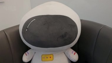 Dental office beautiful decor soft toy in the form of an astronaut sitting in a chair the latest relaxation technologies comfort. High quality 8k footage