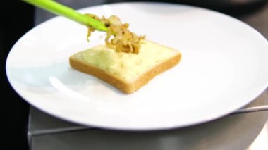Eritilmiş peynirli ve karamelli soğanlı iştah açıcı tost. Kızarmış soğan ve bir dilim ekmek. Yüksek kalite 4k görüntü