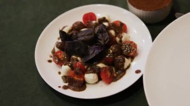 Mavi fesleğen, domates pesto soslu mozzarella soslu caprese salatası. Yüksek kalite 4k görüntü