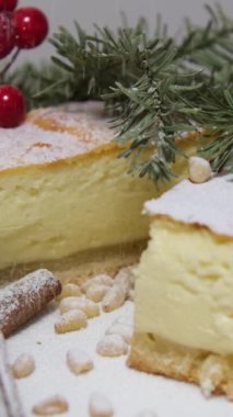 Peynirli krep, pudra şekeri, reçel ve kahverengi tabakta naneli peynirli kek. Noel ağacının arka planında yeni yıl pastası