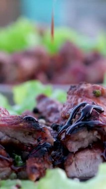 Bifteğin üstüne teriyaki sosu domatesli domuz eti ve karabiberli marul koy. Yüksek kalite 4k görüntü