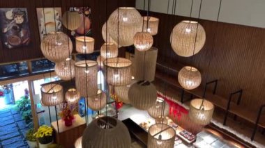 Hasır bir lambaya yakın çekim yapmak sıcak sarı ışık yayarak sıcak bir ortam yaratıyor. İç tasarım ve ortam aydınlatması için ideal. Yüksek kalite 4k görüntü