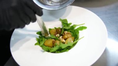 Sebze tabağının arka planında ellerinle marul yapraklarını yırt. Güneşli bir günde sebze salatası hazırlıyorum. Yunan salatası. Şeffaf bir sebze salatası.