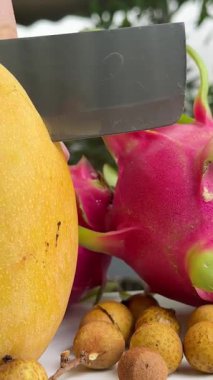 Üstünde koca bir mango olan bir tabak mango dilimi. Mango dilimi küçük parçalara bölündü. Yüksek kalite 4k görüntü