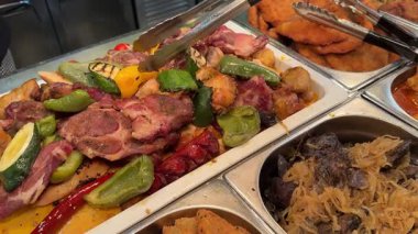 Birçok açık büfe restoranında bol bol et ve sebze var. Lezzetli ve lezzetli. Yiyebildiğiniz kadar yemek yiyebiliyorsunuz. Yüksek kalite 4k görüntü