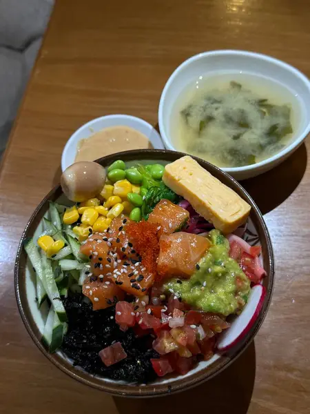 Sebzeli waok pilavı. Siyah arkaplan üzerine kompozisyon. Japon Mutfağı Sanatı. Menü ve suşi bar dekorasyonu için yemek fotoğrafçılığı. Dikey fotoğraf kasesi çorbası