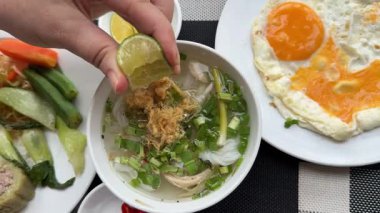Masanın üzerinde duran Vietnamlı geleneksel çorba hobisine farklı baharatlar verin. Asya Oteli 'ndeki diğer besin yumurtalarının sağlıklı kahvaltı büfesinde limon ve kırmızı biber ekleyin. Yüksek kalite