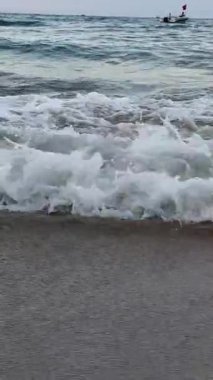 Büyüleyici okyanus dalgaları kumlu kıyı şeridi üst hava manzarası. Okyanusun görkemli dalgaları kumsalın sakin dalgaları okyanus kenarındaki güzel okyanus manzarasının sükunetini okşar. Yüksek