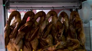 Kızarmış Pekin ördekleri ve parlak derileri sergileniyor, tipik bir Çin restoranında asılılar, aşçılık geleneklerini uyguluyorlar. Yüksek kalite 4k görüntü