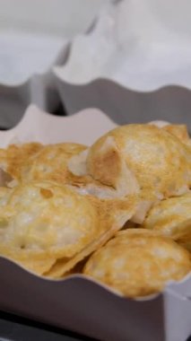 Yakın plan ev yapımı elmalı çörekler ve pudra şekeri. Ev yapımı aromatik hamur işleri daire şeklinde döner, önden, makrodan. Yüksek kalite 4k görüntü