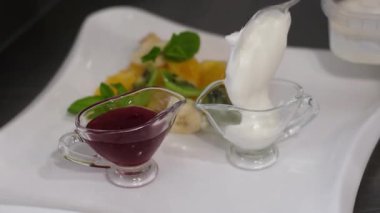 Peynirli krep yapmayı deneyin reçelli ekşi krema ve muz parçaları adım adım meyveler beyaz bir tabakta pudra şekerle süslenir. Yüksek kalite 4k görüntü