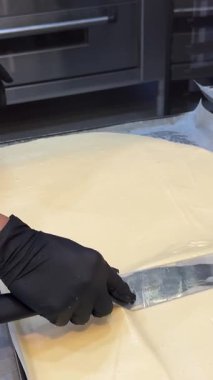 Pastanelerde tatlı yapma süreci hamur işi eldivenlerle çalışma kalıplardan daireler kesme pasta pişirme aşçısı tatlıları pişirme.