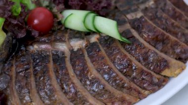 Salatalık sebzeleri için süslenmiş beyaz bir tabakta içi doldurulmuş balık masasında domatesler yeri doldurulamaz bir yemek. Yüksek kalite 4k görüntü