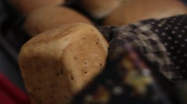 Olgun bir kadın için fırından çıkarılan sıcak ekmek fırını açar, bir somun taze ekmeği çıkarır ve evinde serinlemek için ocağın tepesini koklar. Yüksek kalite 4k görüntü