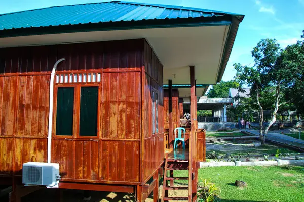 Traditional Bugis wooden house villa with blue roof and courtyard house