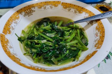 Yemek odasındaki yemek masasındaki tabakta lahana sebzesi.