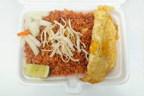 Indonesian food - red fried rice in a rice box on the dining table