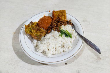 Food Indonesia Mixed rice on a plate at the dining table clipart