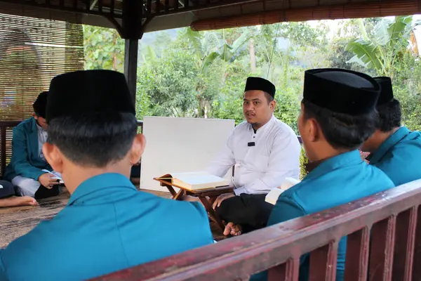 stock image Gowa, Indonesia - 10 July 2024 : Muslim students sitting listening in the mosque