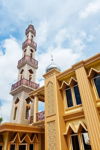 stock image The front view of the yellow mosque tower