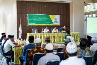 Endonezya, Makassar, 28 Ekim 2024. Oturan insanlar bir seminere katılıyor.